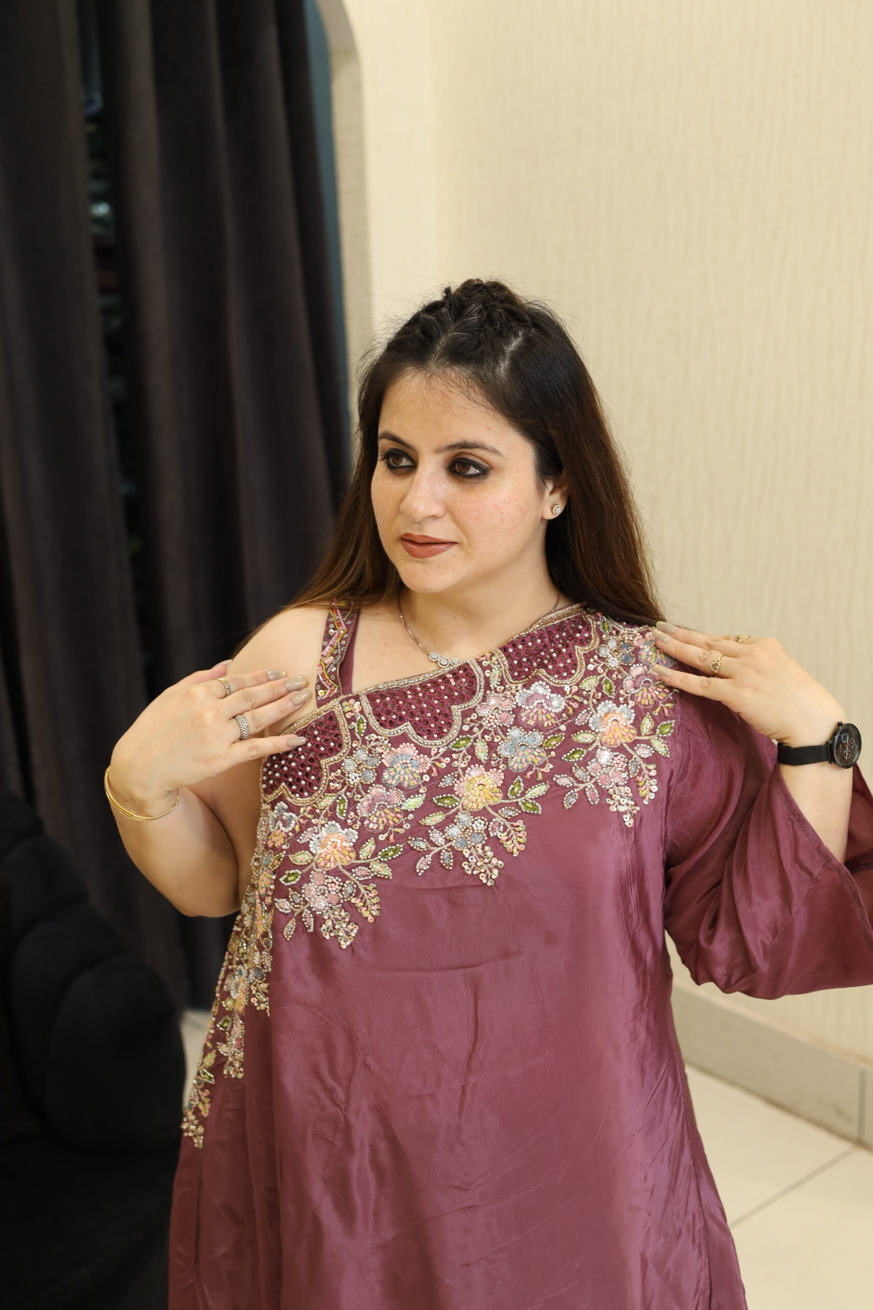 Woman in a floral embroidered maroon co-ord set with braided hair