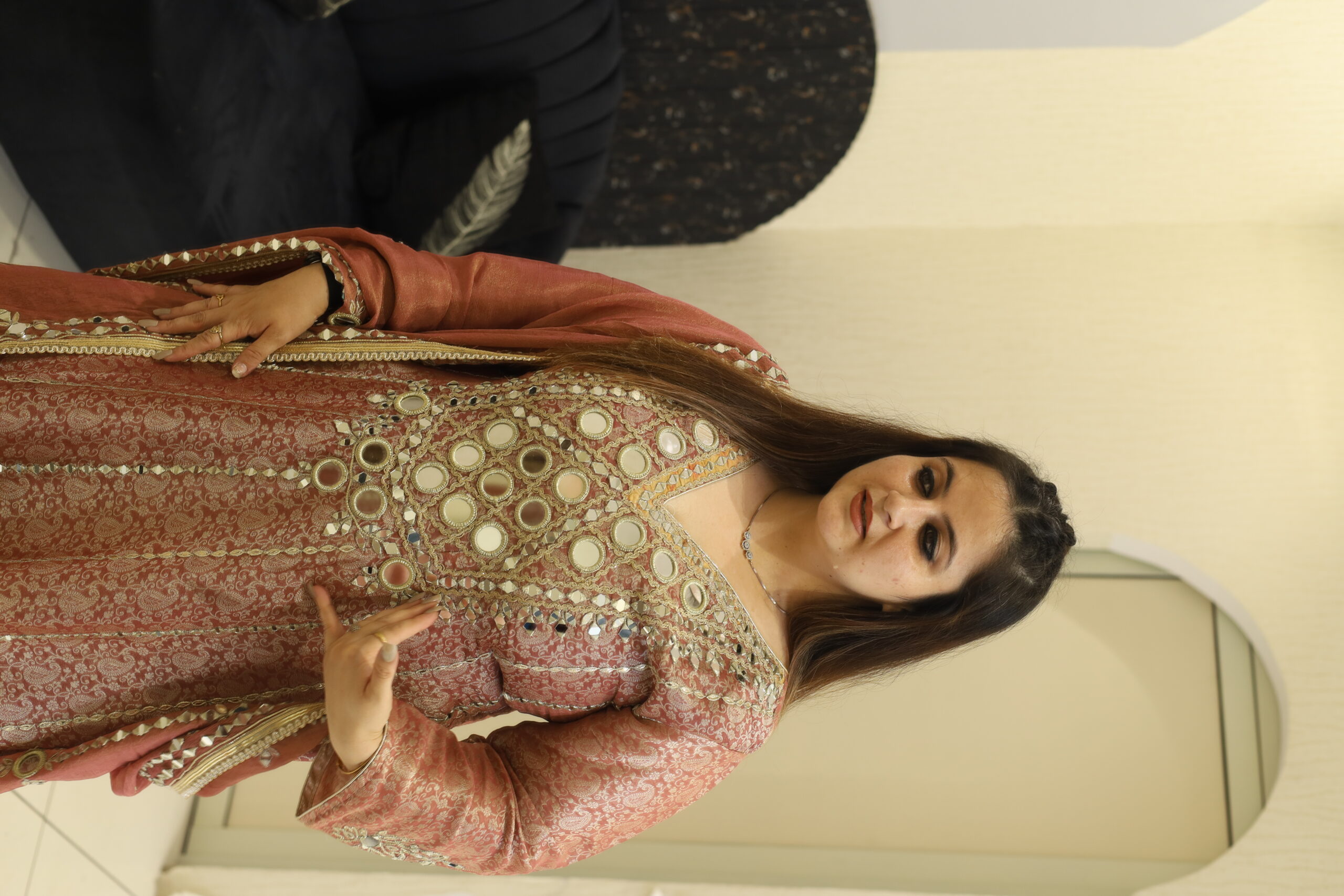 Woman wearing a pink floral embroidered button-down co-ord set with long sleeves