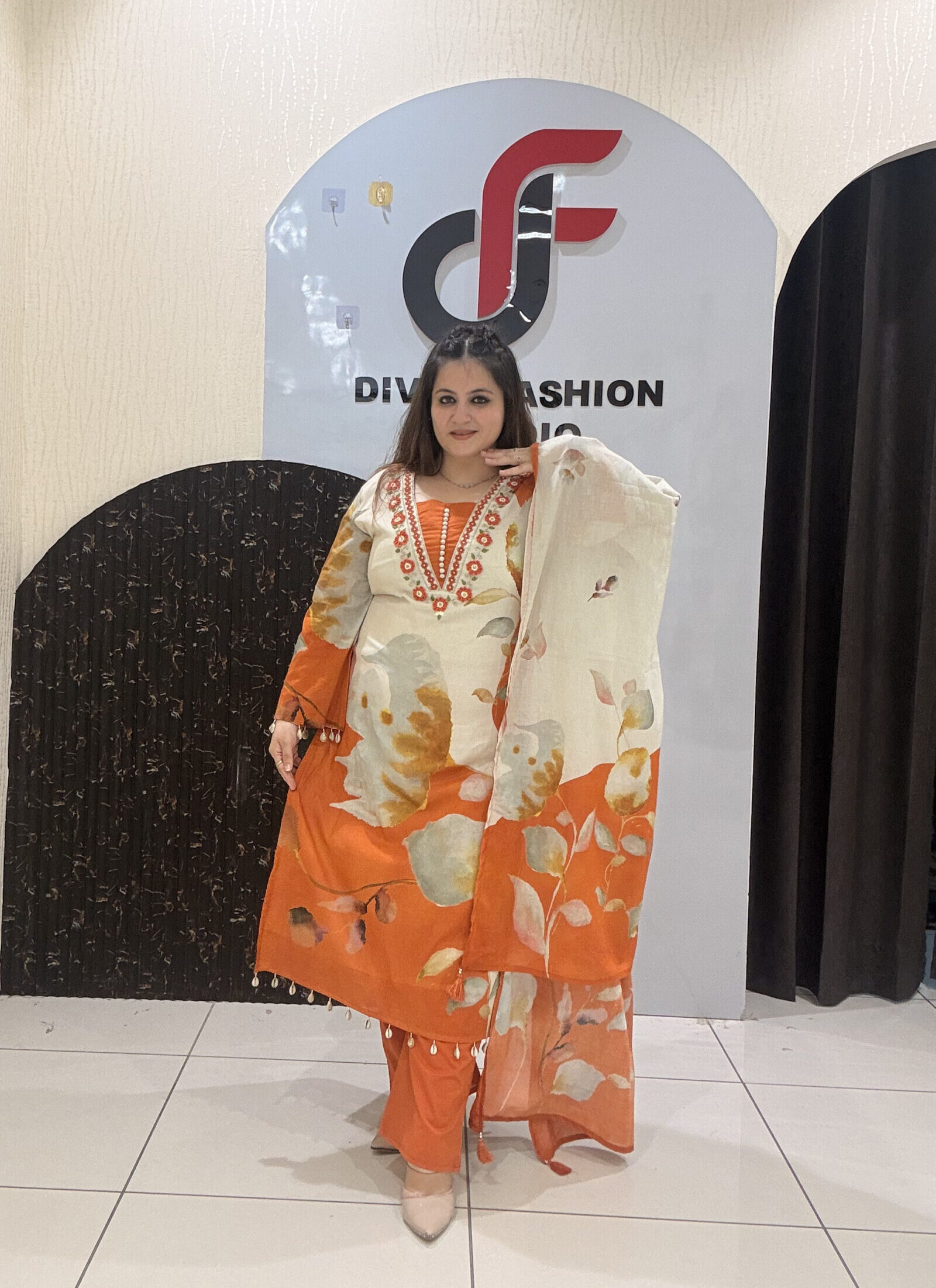 Elegant pure mul cotton suit featuring a beautiful leaf print in warm tones of orange and cream