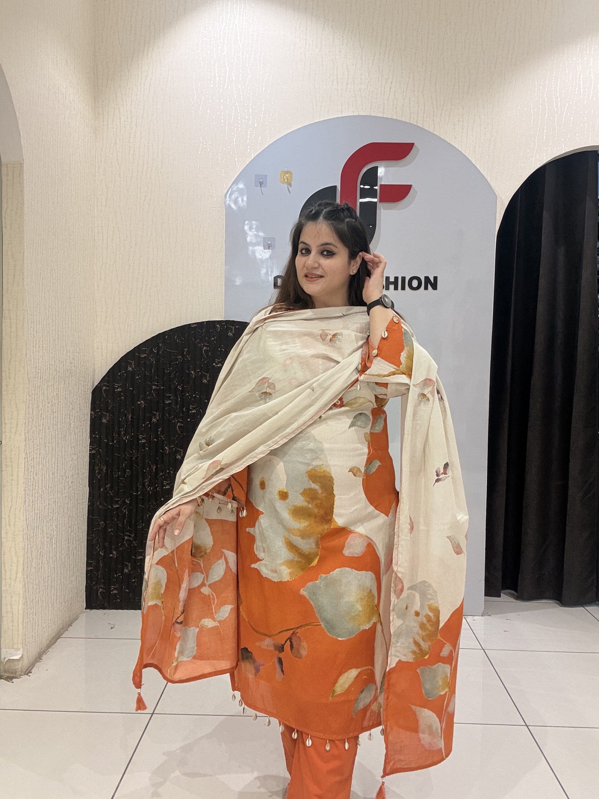 Elegant pure mul cotton suit featuring a beautiful leaf print in warm tones of orange and cream