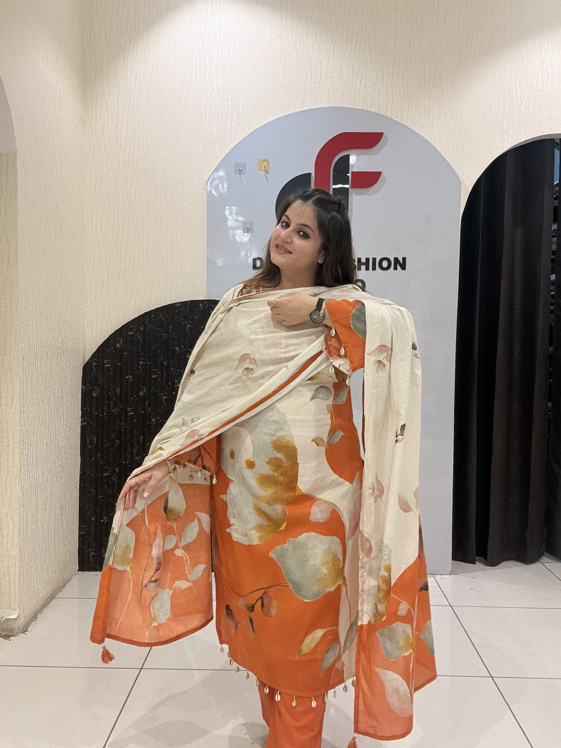 Elegant pure mul cotton suit featuring a beautiful leaf print in warm tones of orange and cream