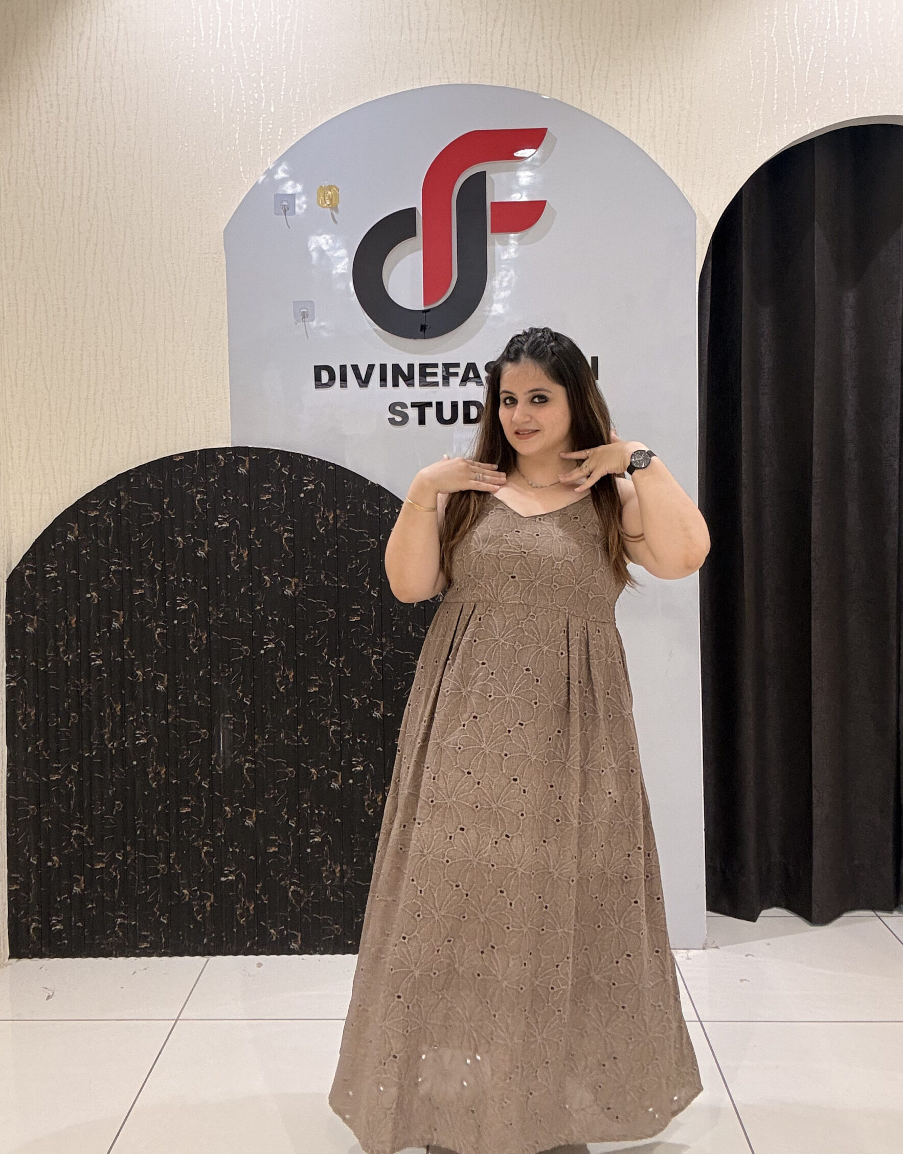 Stylish sleeveless cotton middi dress featuring delicate embroidery and a flowy silhouette