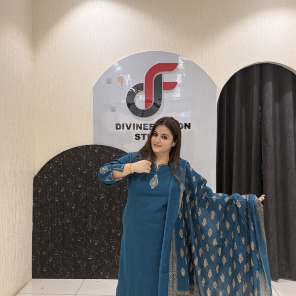 Elegant teal cotton suit featuring a delicate embroidered motif and a matching Kota Doria dupatta with golden patterns.
